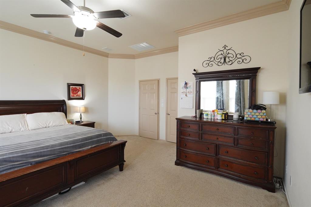 4508 Fox Rio Trail Arlington, TX 76017 - Photo 17 of 28 a bedroom with a bed and a chandelier