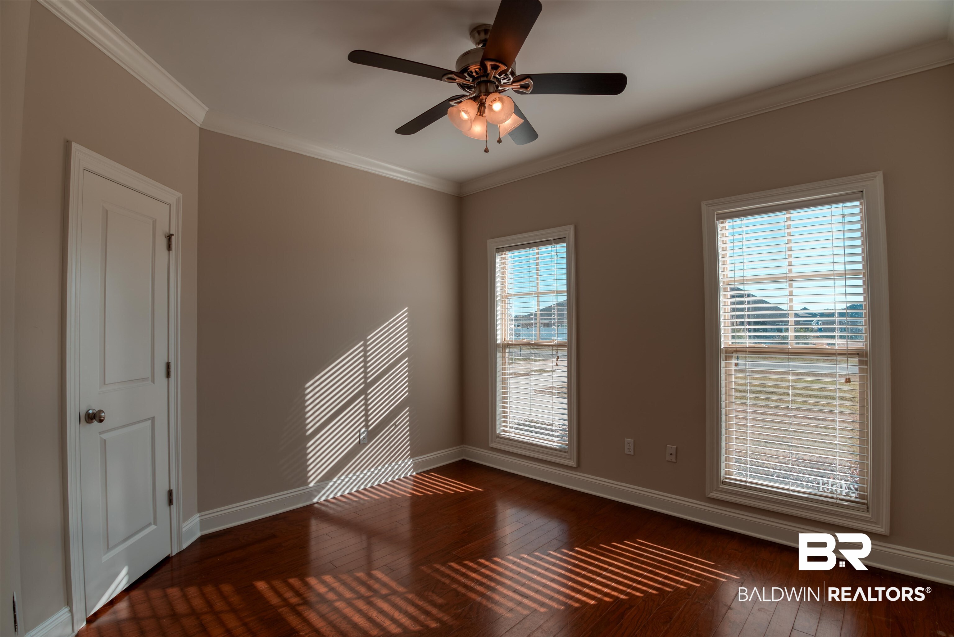 24561 Austin Road Daphne, AL 36526 - Photo 27 of 57 Empty room with ceiling fan, crown molding, and dark wood-type flooring