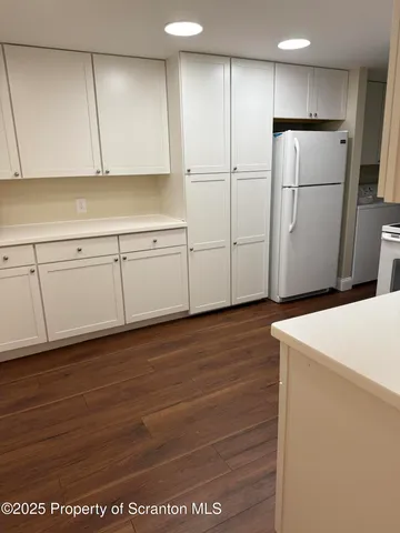 a view of cabinets with wooden floor