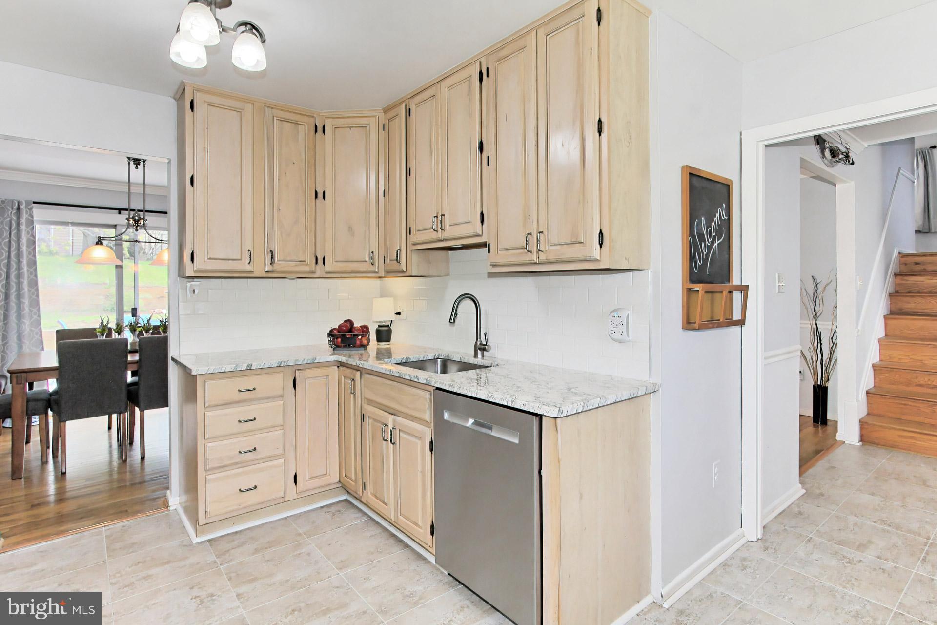 6011 Meriwether Lane Springfield, VA 22150 - Photo 16 of 53 a kitchen with stainless steel appliances granite countertop a sink and cabinets