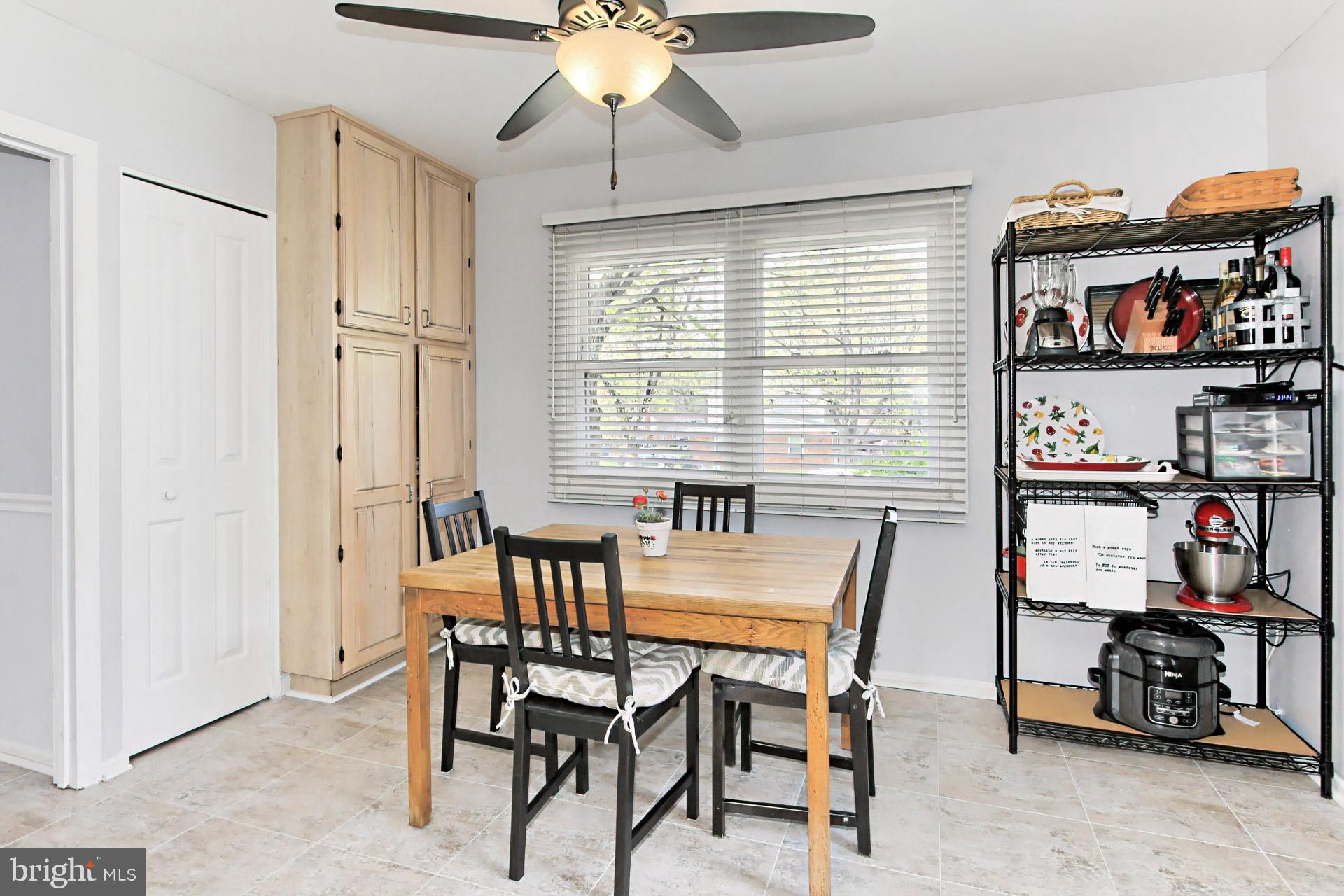 6011 Meriwether Lane Springfield, VA 22150 - Photo 17 of 53 a dining room with furniture and a book shelf