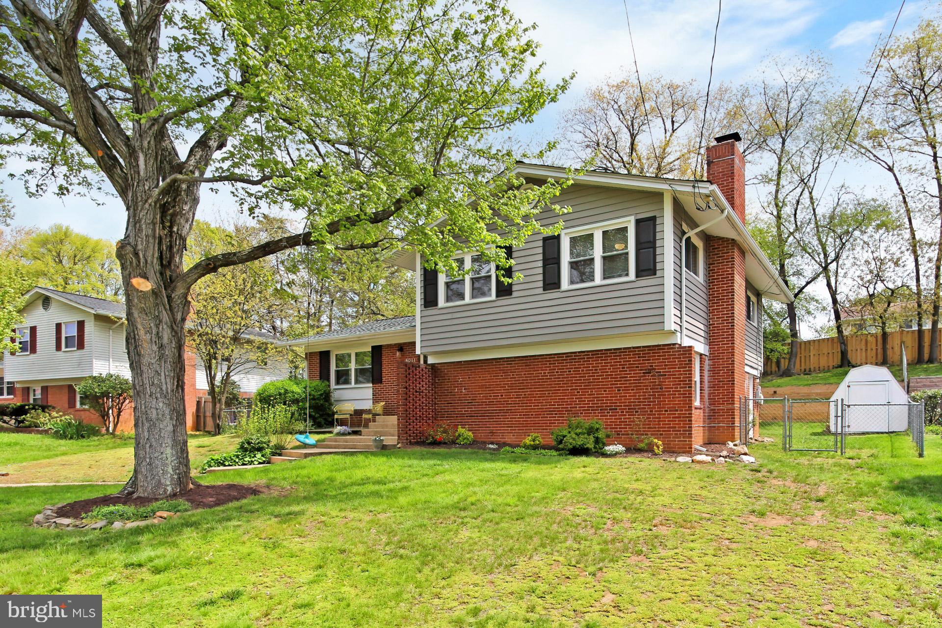6011 Meriwether Lane Springfield, VA 22150 - Photo 3 of 53 a front view of a house with garden