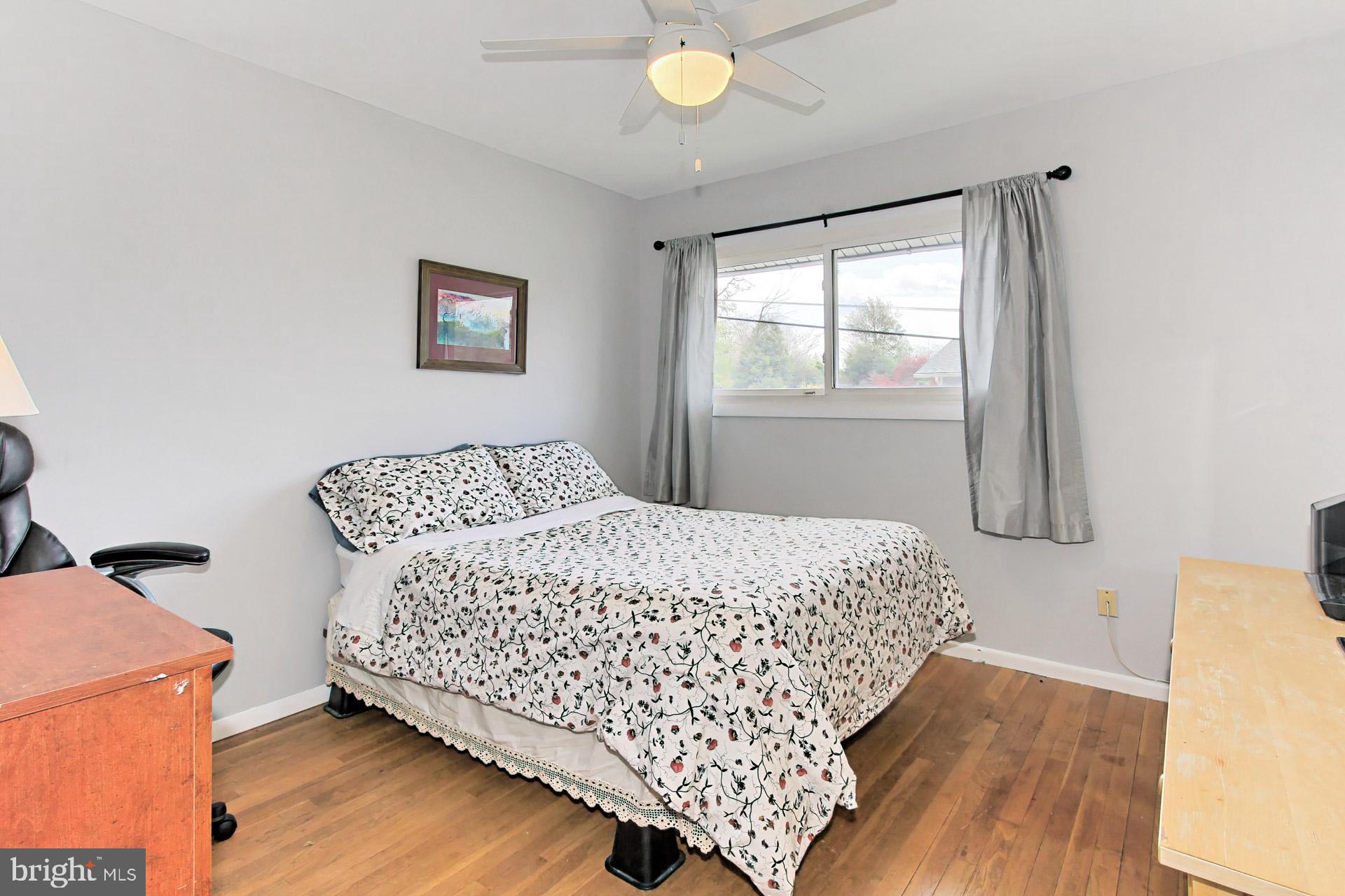 6011 Meriwether Lane Springfield, VA 22150 - Photo 22 of 53 a bedroom with a bed and wooden floor