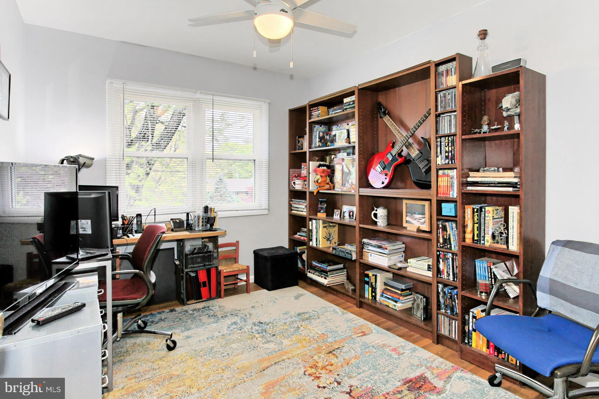 6011 Meriwether Lane Springfield, VA 22150 - Photo 24 of 53 a view of a workspace with bookshelf and a window