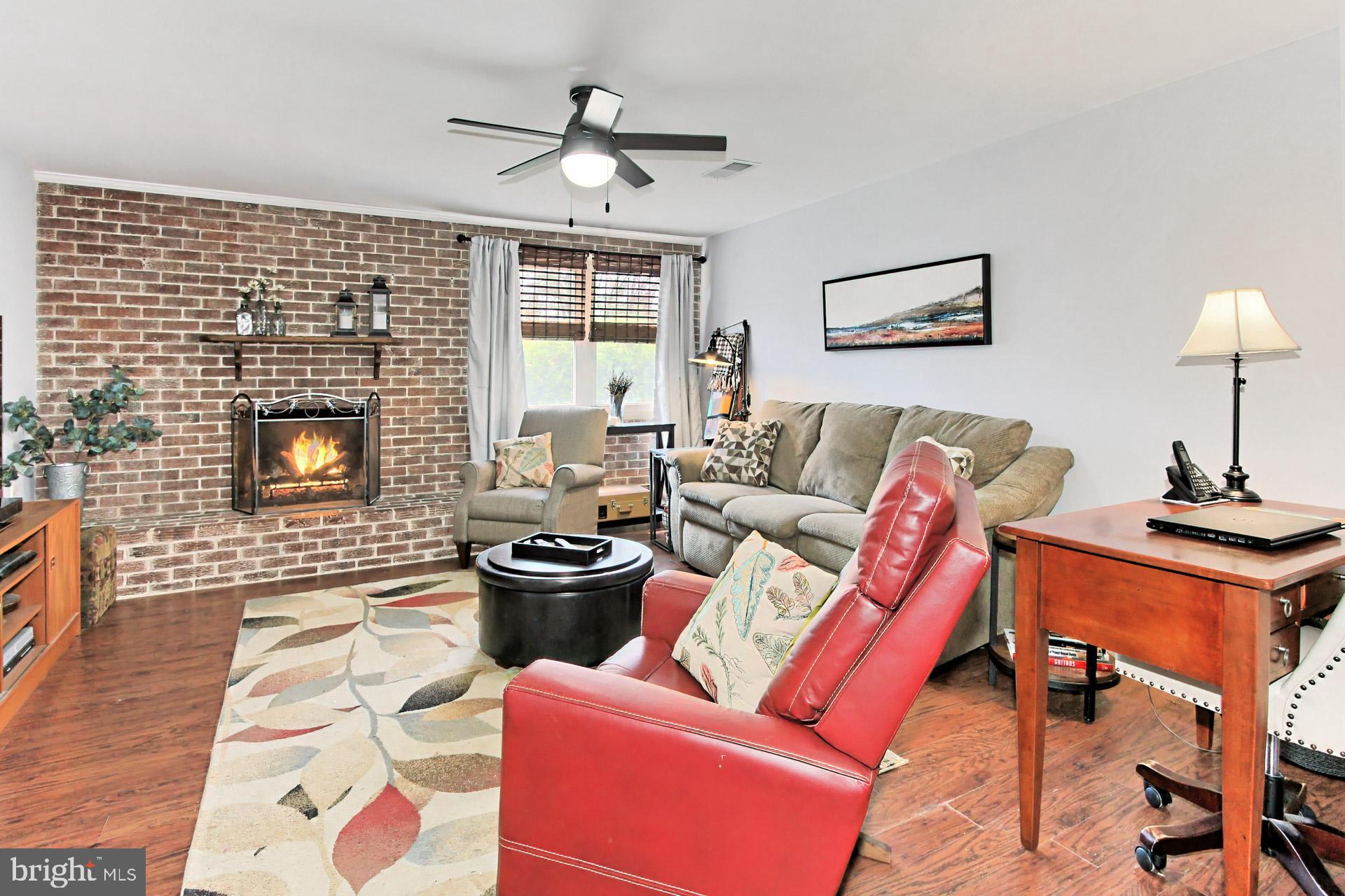 6011 Meriwether Lane Springfield, VA 22150 - Photo 27 of 53 a living room with furniture and a fireplace