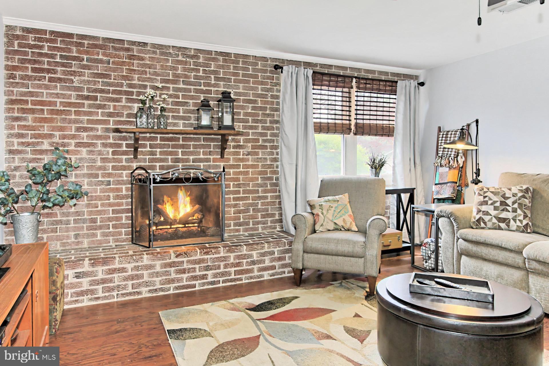 6011 Meriwether Lane Springfield, VA 22150 - Photo 28 of 53 a living room with furniture and a fireplace