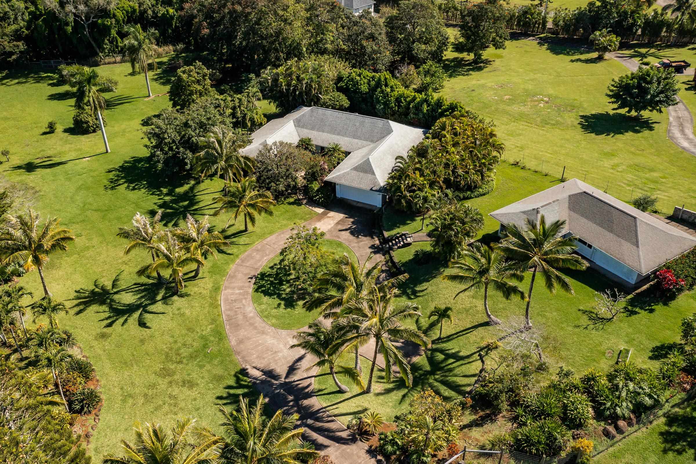 an aerial view of residential house with swimming pool and lawn chairs