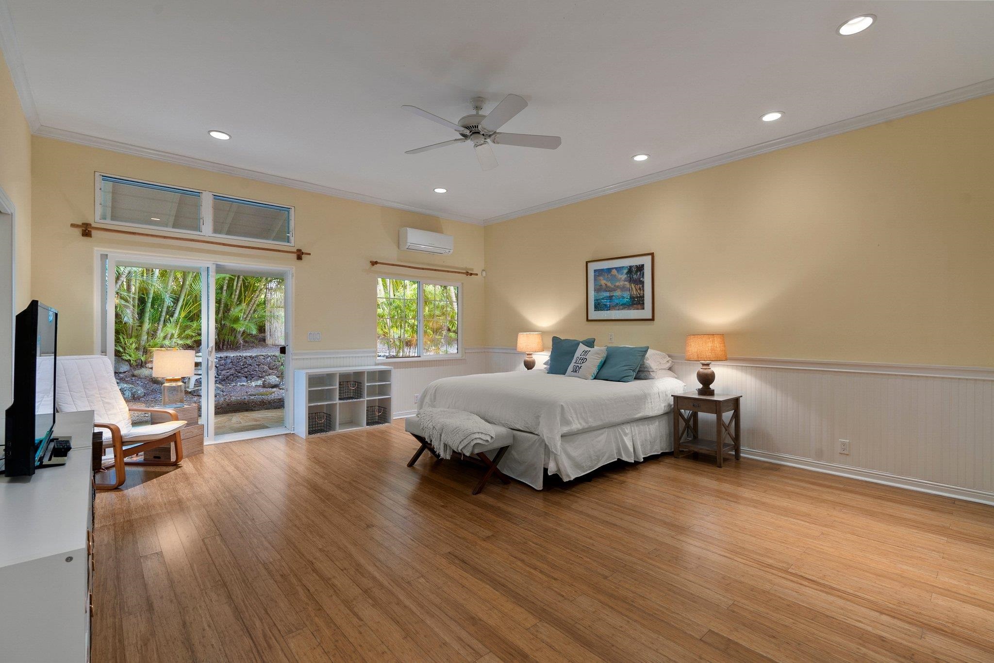 370 Waiama Way Haiku, HI 96708 - Photo 14 of 24 a spacious bedroom with a bed a table and a large window