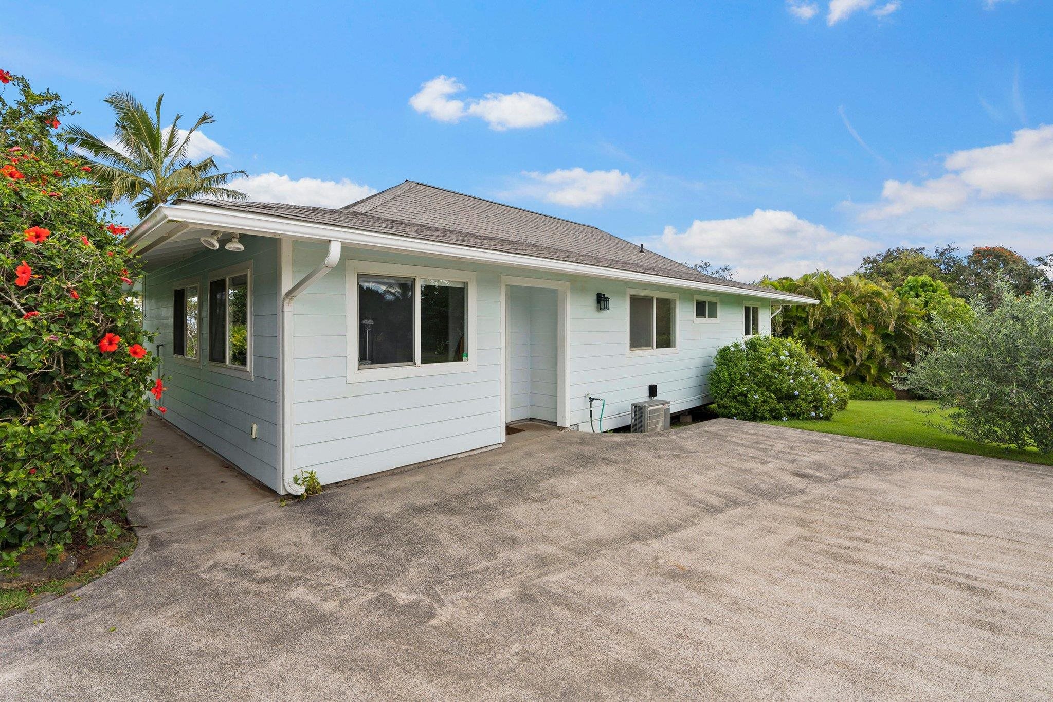 370 Waiama Way Haiku, HI 96708 - Photo 20 of 24 a view of a white house with a big yard and potted plants