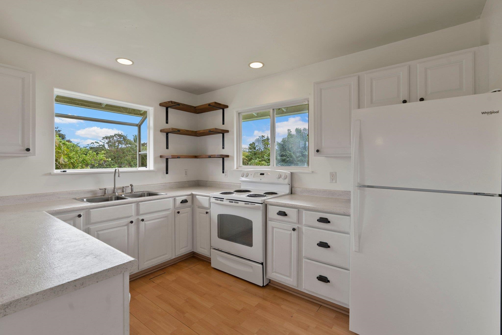 370 Waiama Way Haiku, HI 96708 - Photo 21 of 24 a kitchen with white cabinets and white appliances