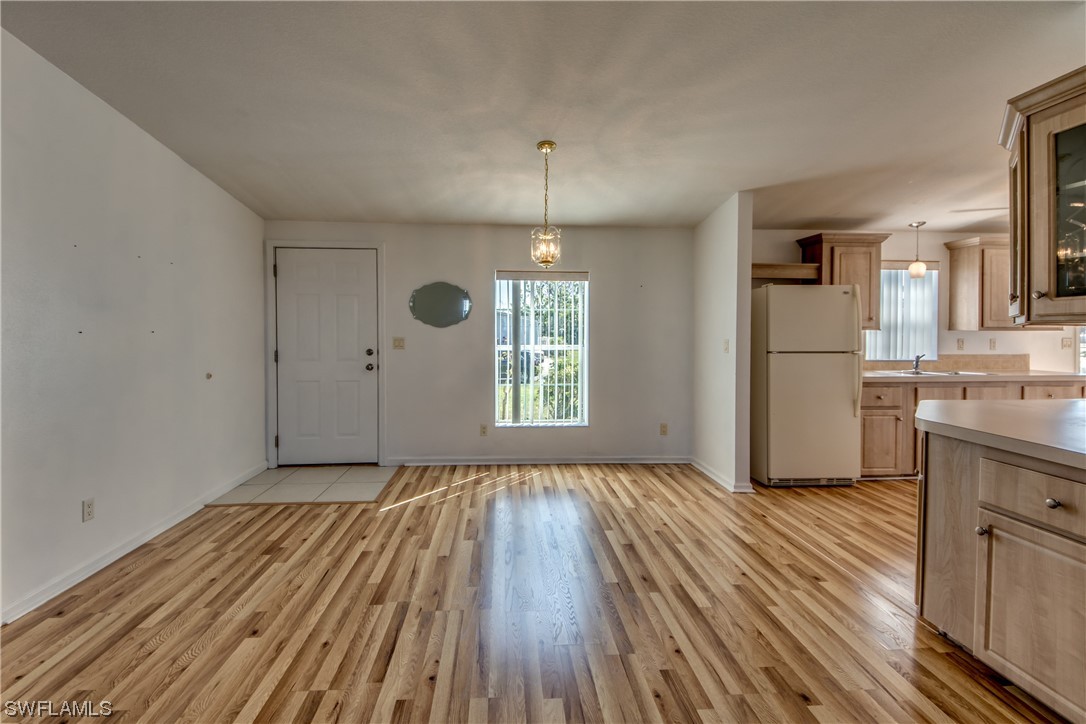 7602 Helen Road Bokeelia, FL 33922 - Photo 4 of 35 a view of a kitchen with wooden floor and a sink