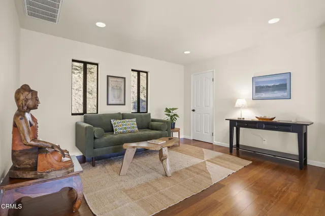 a living room with furniture a window and gym equipment