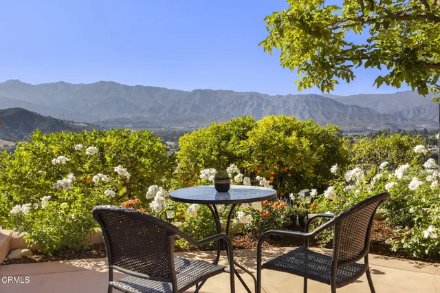 a view of a chairs and table in the patio