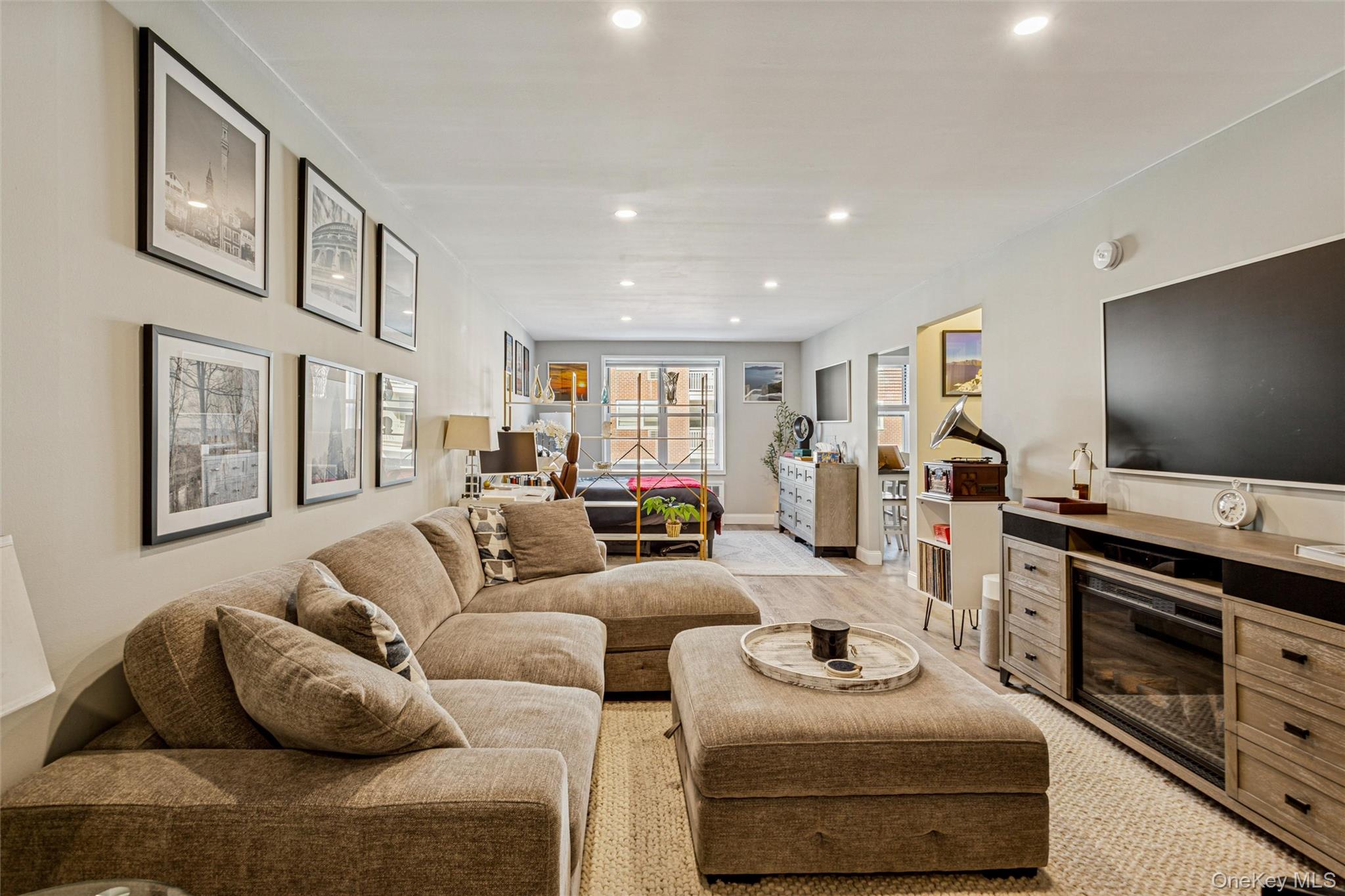 700 Shore Road, Unit 5U Long Beach, NY 11561 - Photo 7 of 21 a living room with furniture and a flat screen tv