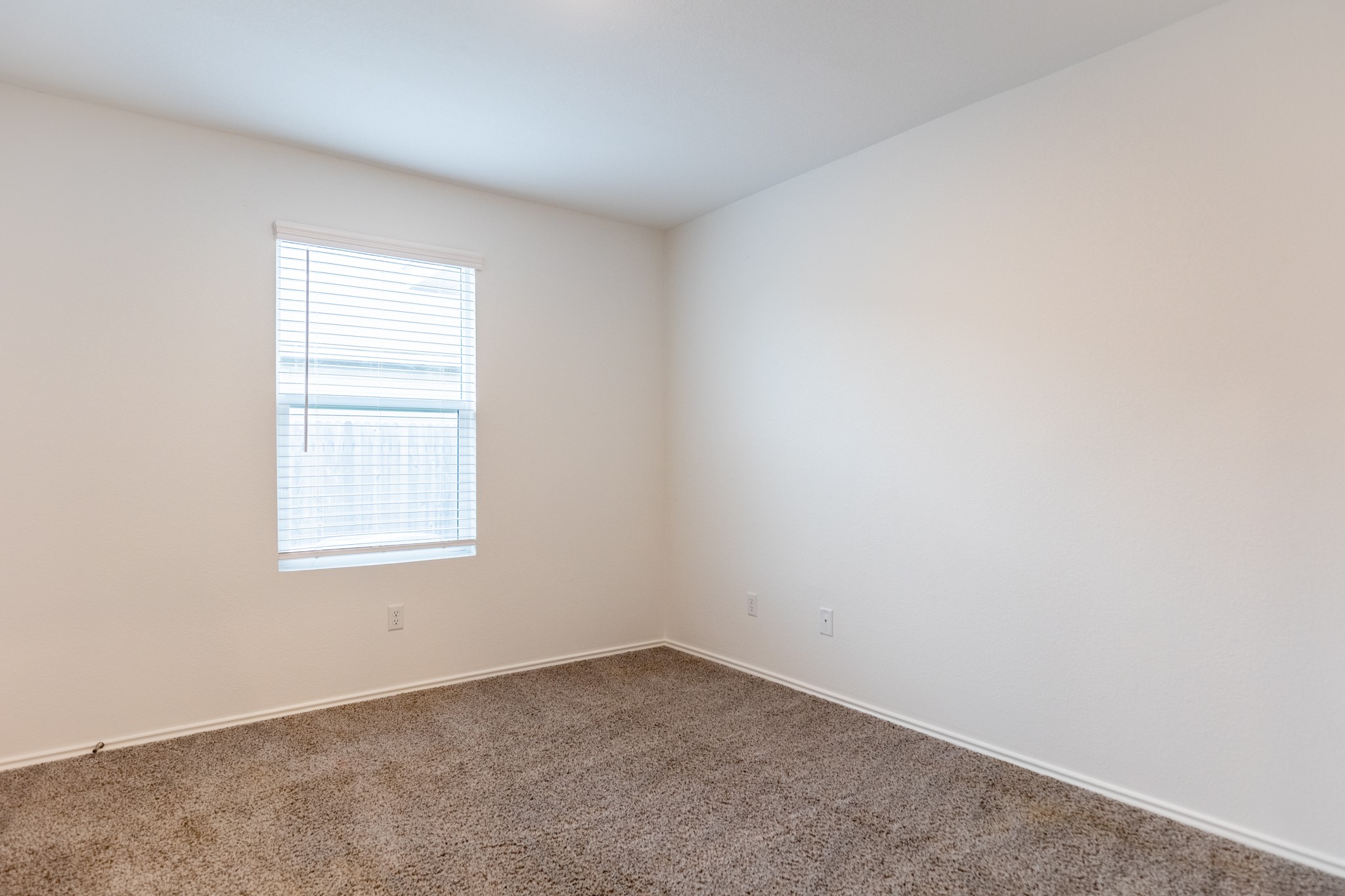 175 Silver Springs Bend Kyle, TX 78640 - Photo 17 of 33 Empty room featuring baseboards and carpet