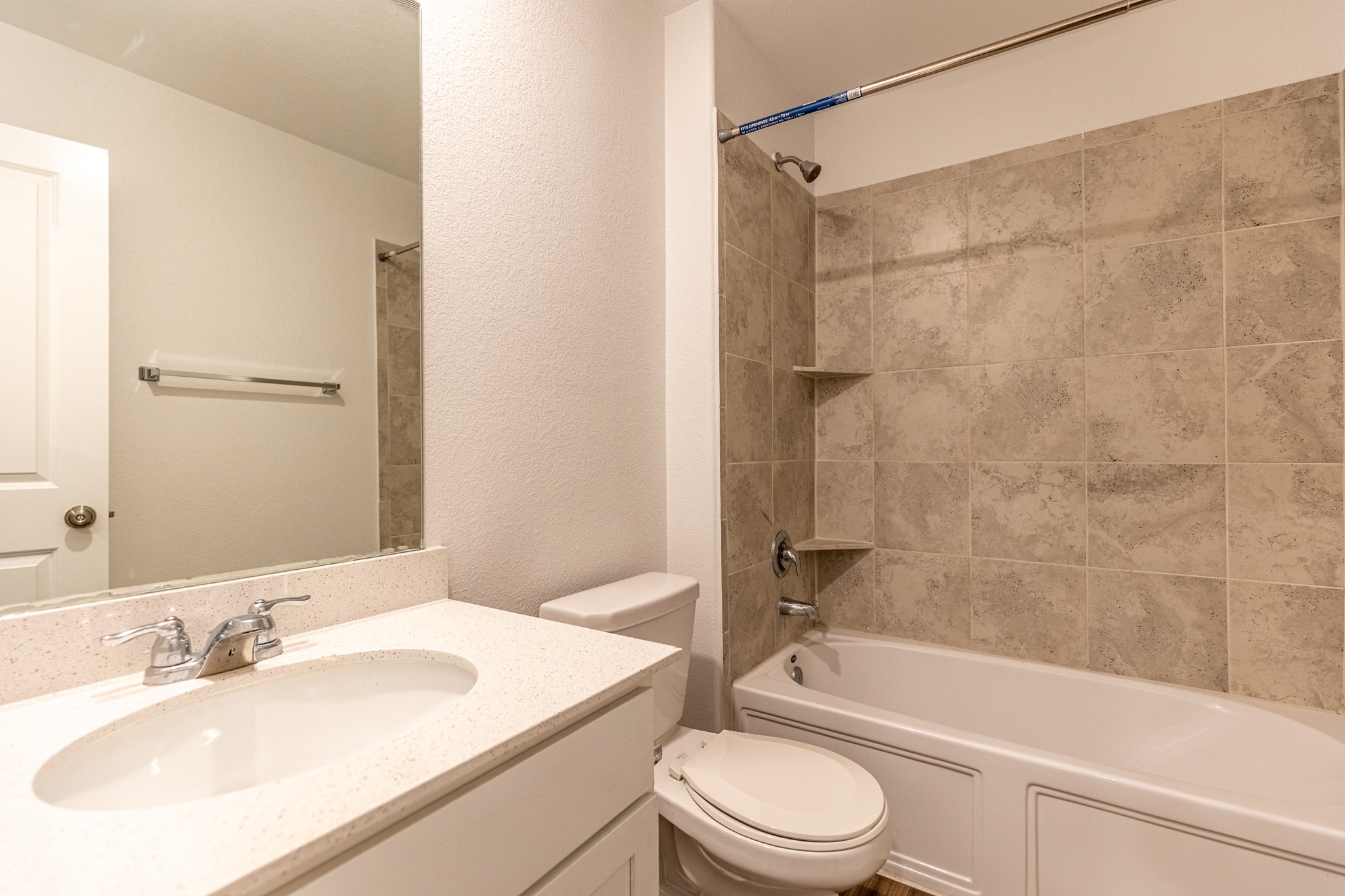 175 Silver Springs Bend Kyle, TX 78640 - Photo 21 of 33 Full bath featuring a textured wall, vanity, and shower / bathtub combination