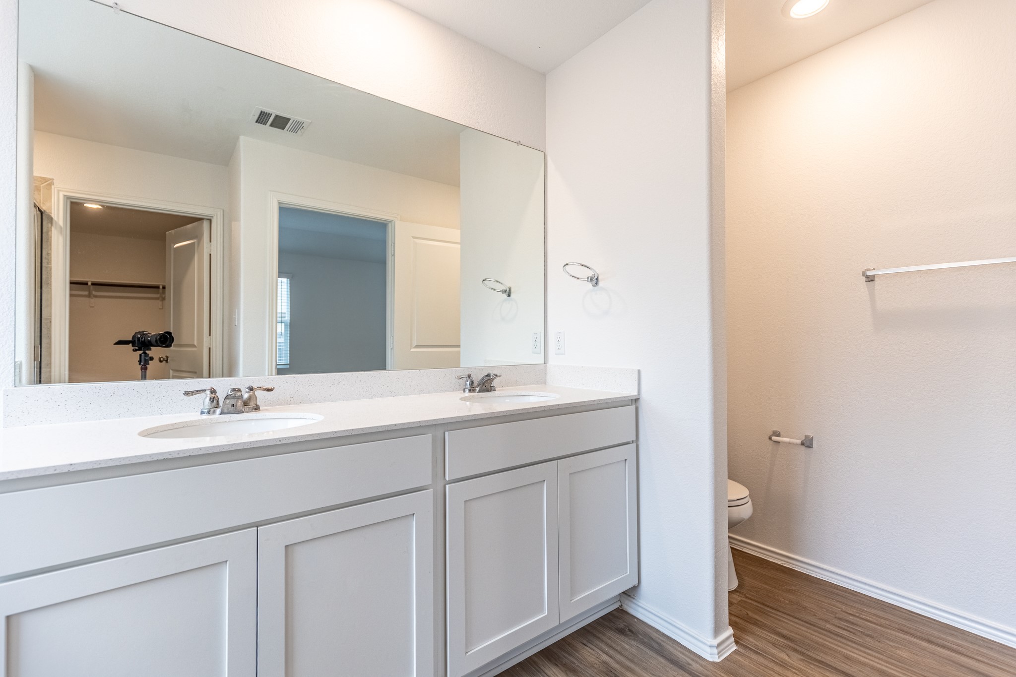 175 Silver Springs Bend Kyle, TX 78640 - Photo 27 of 33 Bathroom with a walk in closet, double vanity, dark wood finished floors, and recessed lighting