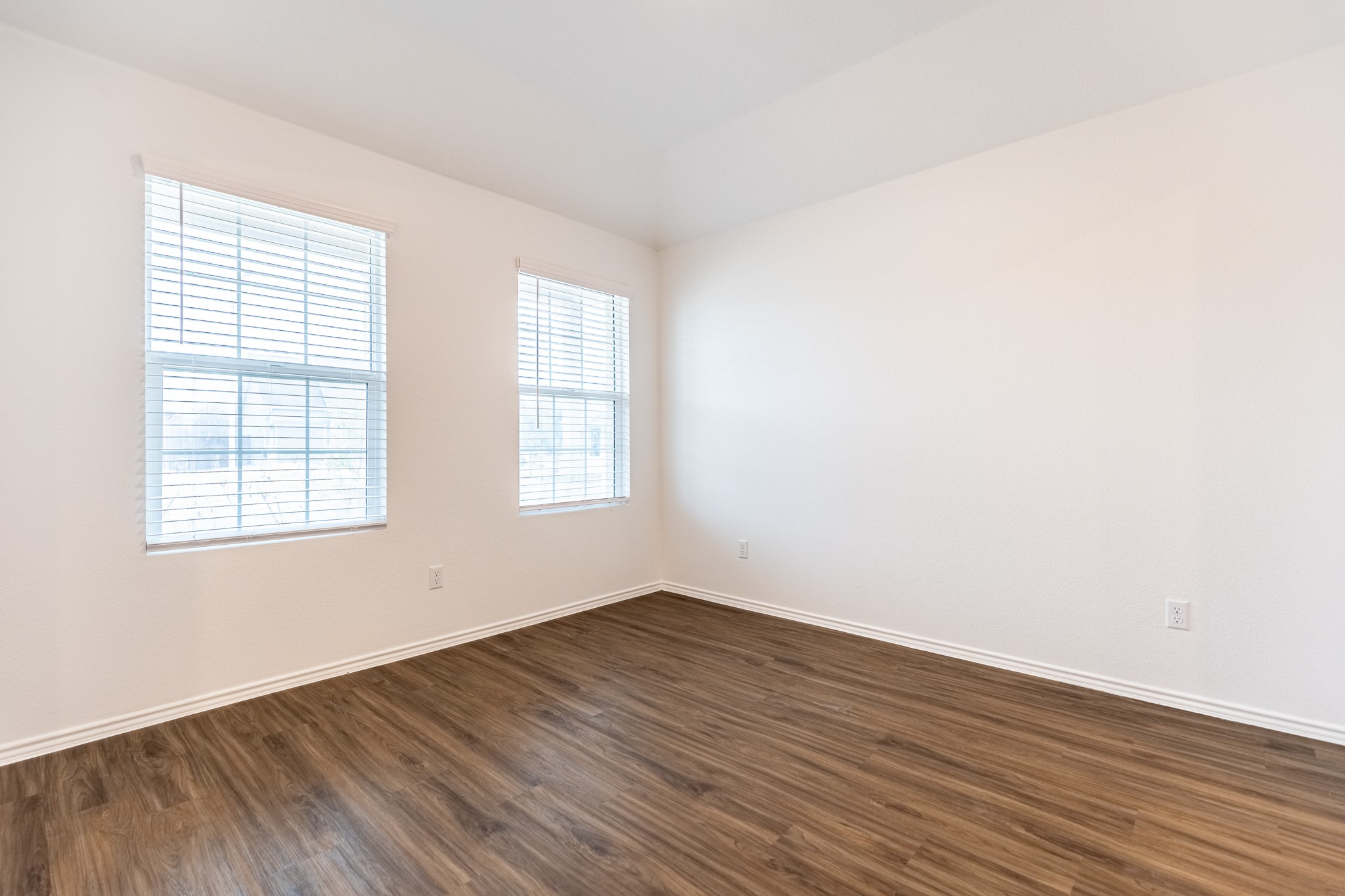 175 Silver Springs Bend Kyle, TX 78640 - Photo 5 of 33 Empty room with dark wood finished floors and baseboards
