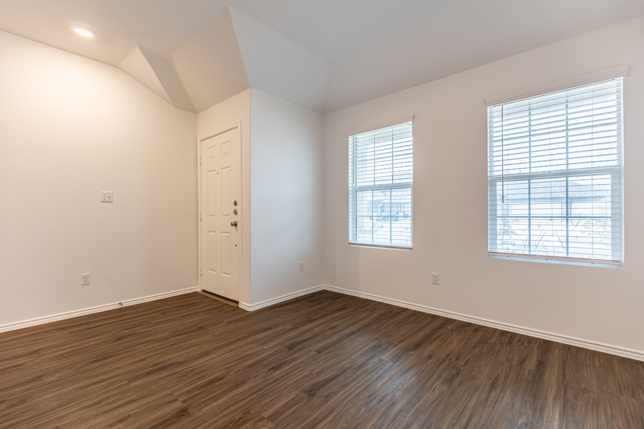 175 Silver Springs Bend Kyle, TX 78640 - Photo 6 of 33 Unfurnished room featuring dark wood finished floors, lofted ceiling, and recessed lighting