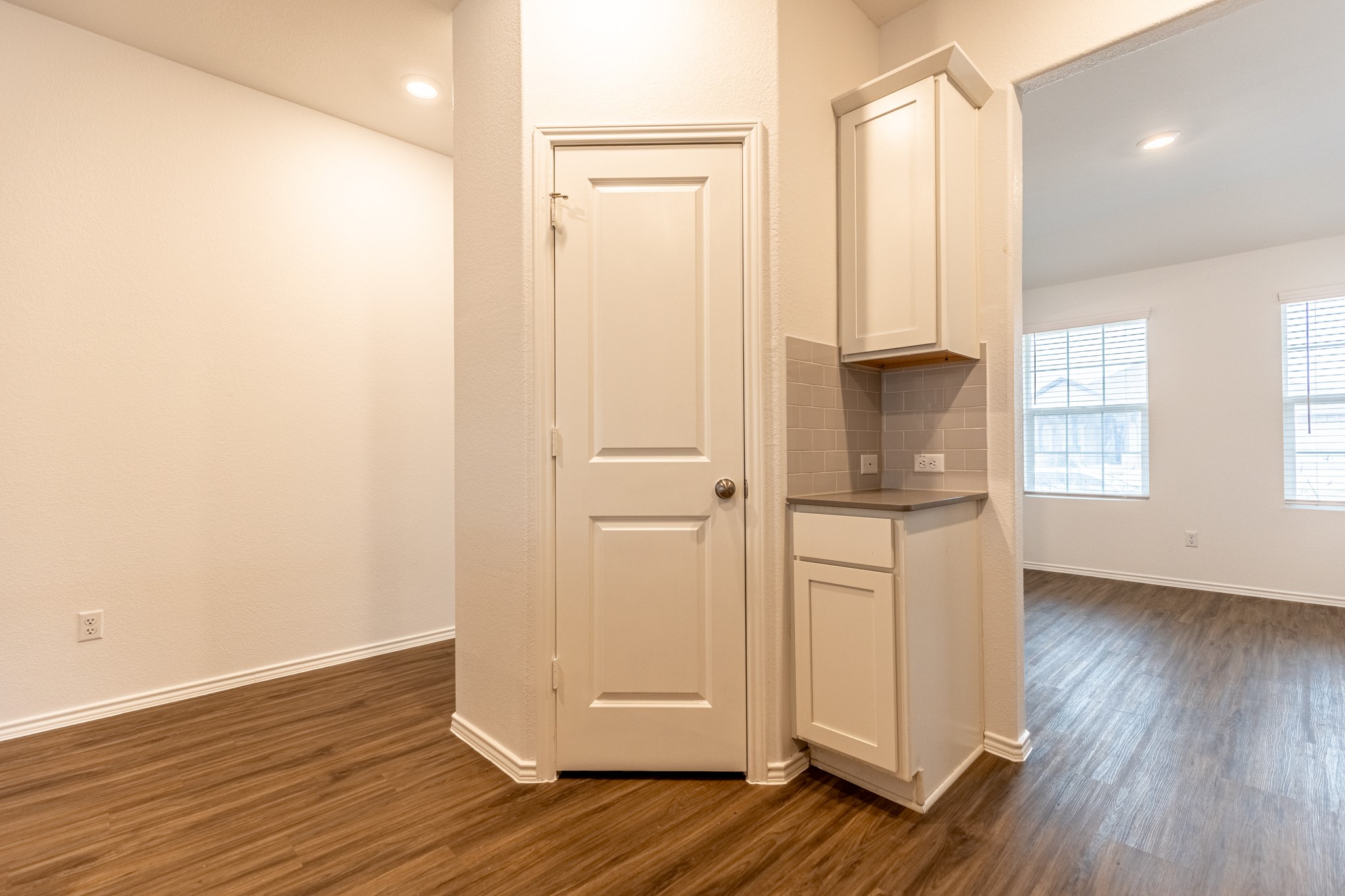 175 Silver Springs Bend Kyle, TX 78640 - Photo 9 of 33 Kitchen with dark wood-style floors, white cabinetry, decorative backsplash, and recessed lighting