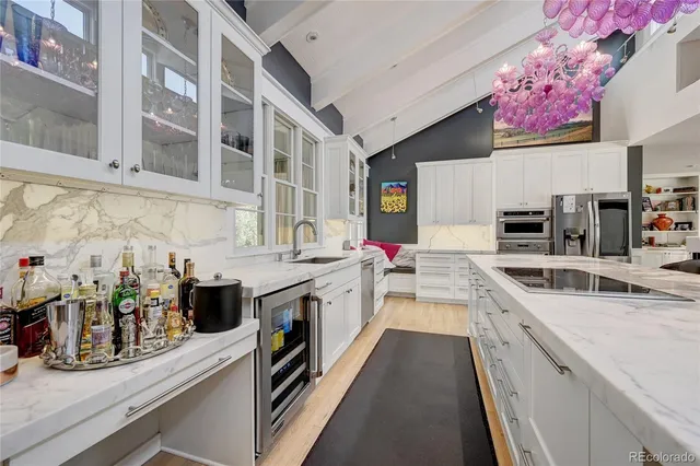 a kitchen with stainless steel appliances granite countertop a sink and stove