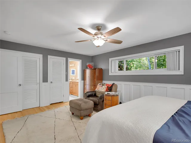a bedroom with two large bed and a chandelier