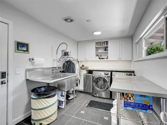 a utility room with sink dryer and washer