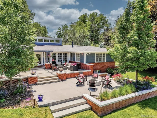 a building outdoor space with patio furniture and potted plants