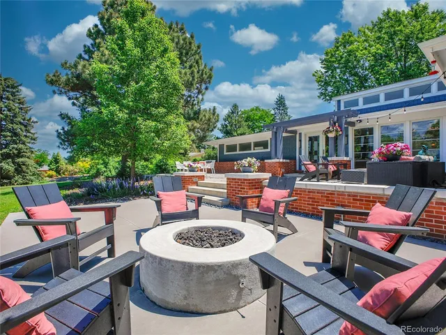 an aerial view of a house with yard and trampoline
