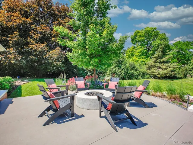 a building outdoor space with patio furniture and potted plants