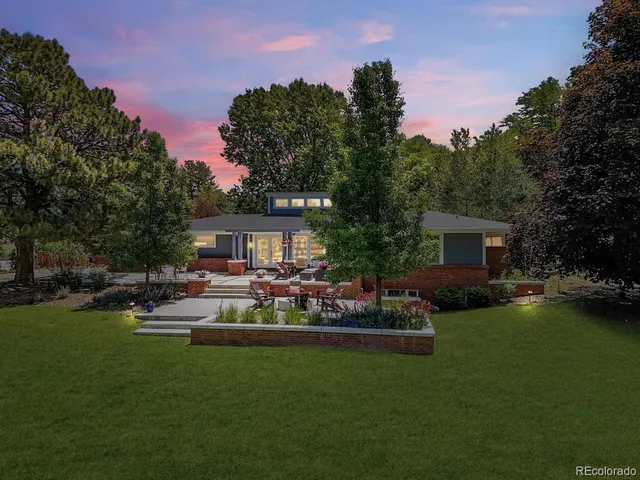 a view of a house with backyard and sitting area