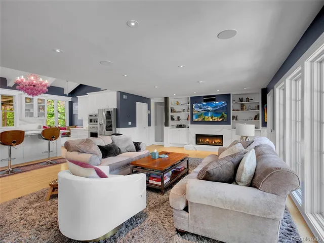 a living room with furniture and a floor to ceiling window