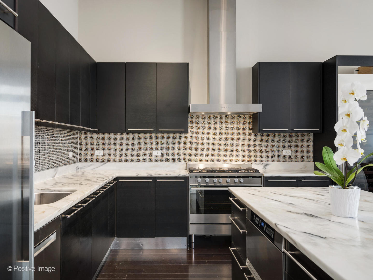 23 North Aberdeen Street, Unit 4S Chicago, IL 60607 - Photo 11 of 24 a kitchen with stainless steel appliances a sink a stove and a refrigerator