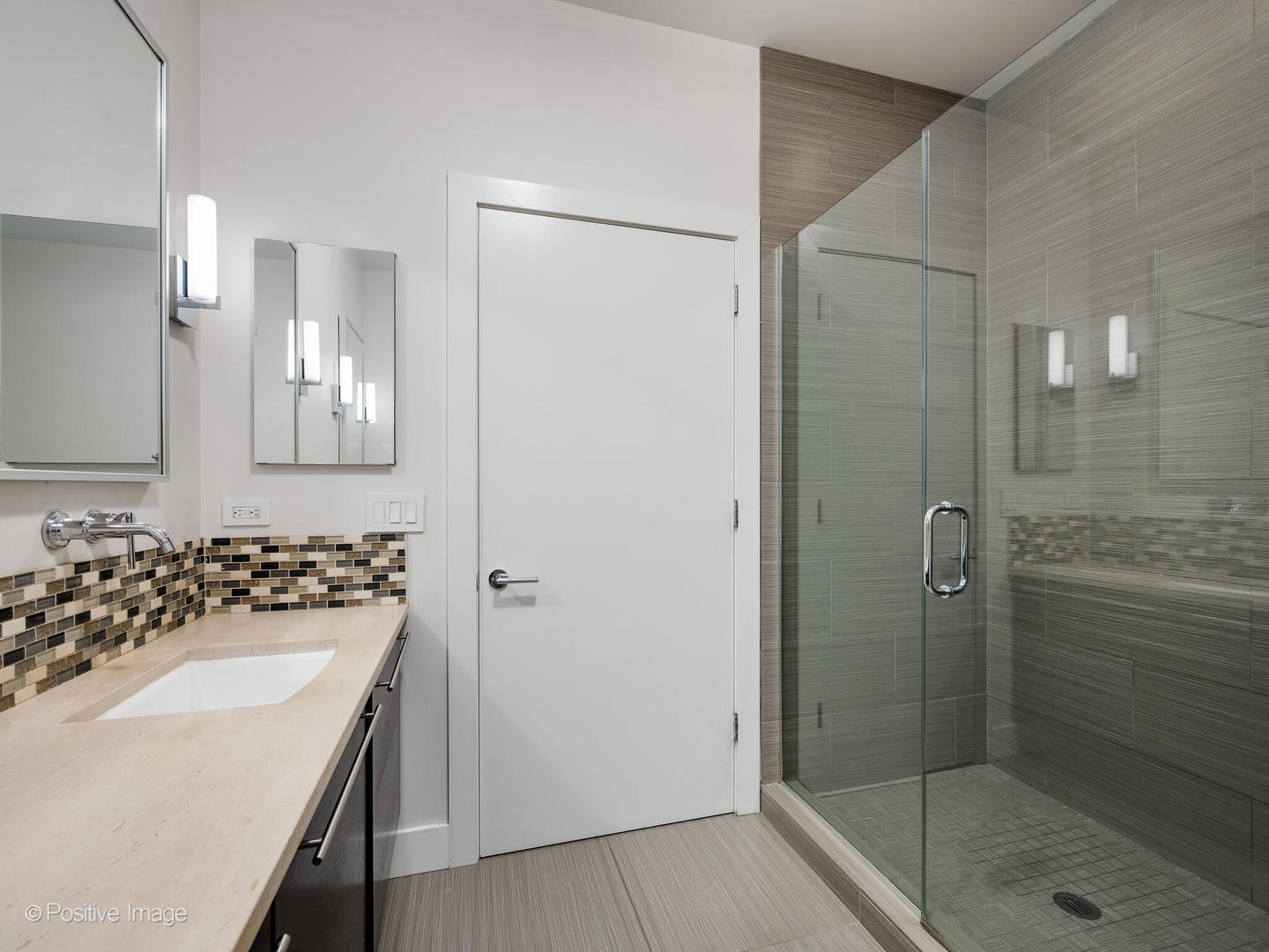 23 North Aberdeen Street, Unit 4S Chicago, IL 60607 - Photo 18 of 24 a bathroom with a shower sink vanity and mirror