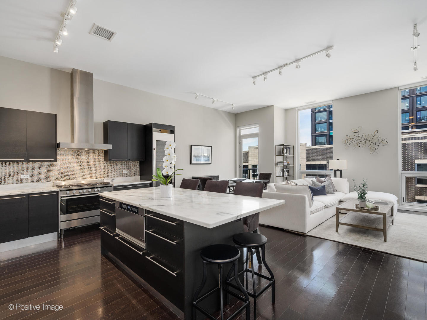 23 North Aberdeen Street, Unit 4S Chicago, IL 60607 - Photo 2 of 24 a large kitchen with a table chairs sink and wooden floor