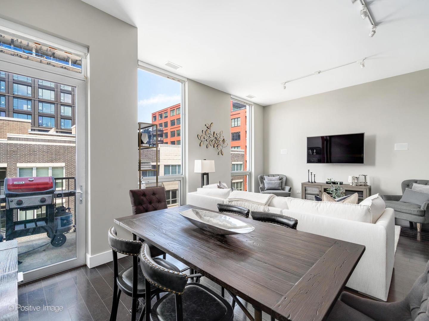 23 North Aberdeen Street, Unit 4S Chicago, IL 60607 - Photo 8 of 24 a living room with furniture and a flat screen tv