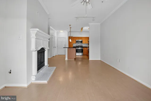 a view of a kitchen with a sink and a refrigerator