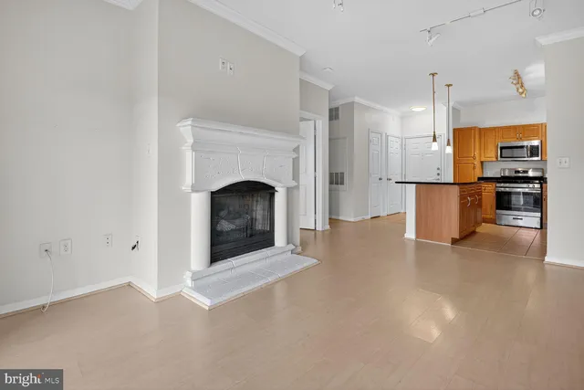 a view of a kitchen with a sink a fireplace and cabinets