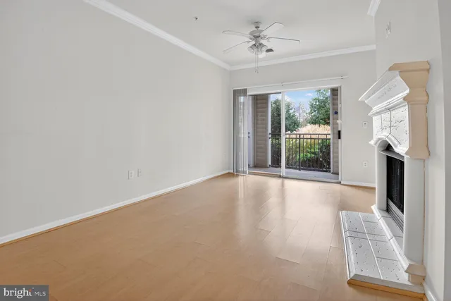 a view of an empty room with a fireplace and a window