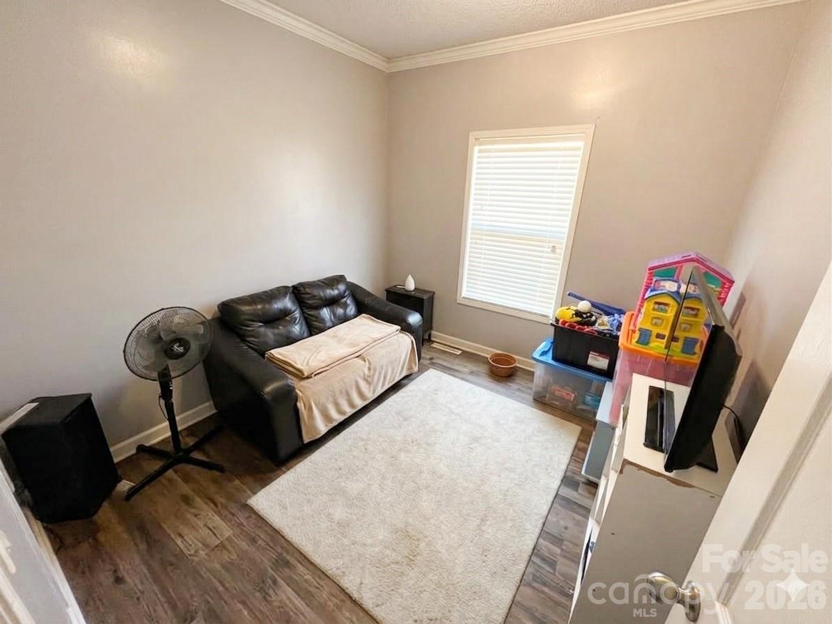 3233 Alamo Drive Trinity, NC 27370 - Photo 12 of 15 a bedroom with a bed and wooden floor