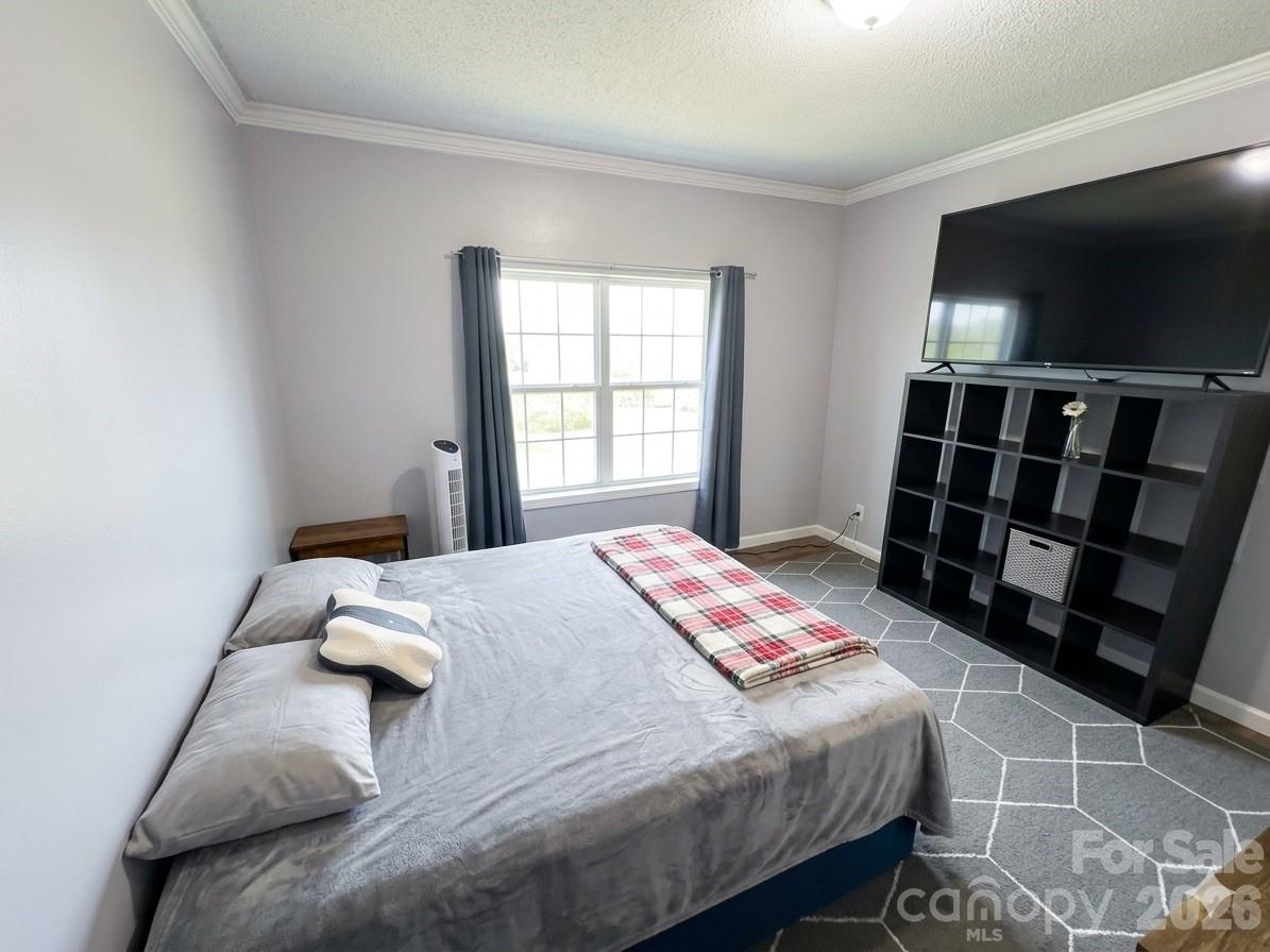 3233 Alamo Drive Trinity, NC 27370 - Photo 8 of 15 a bedroom with a bed and a flat screen tv