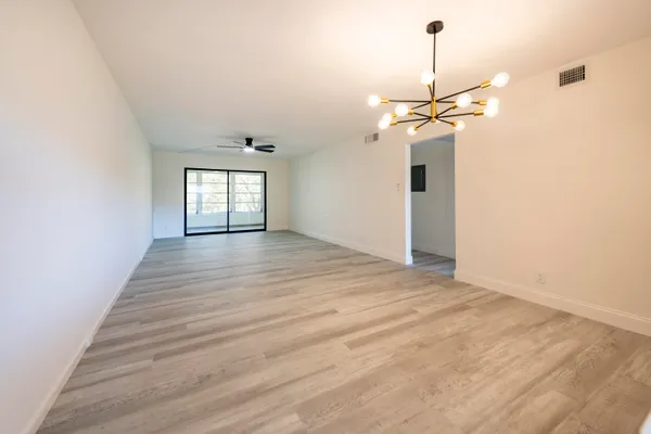 a view of a room with wooden floor and windows