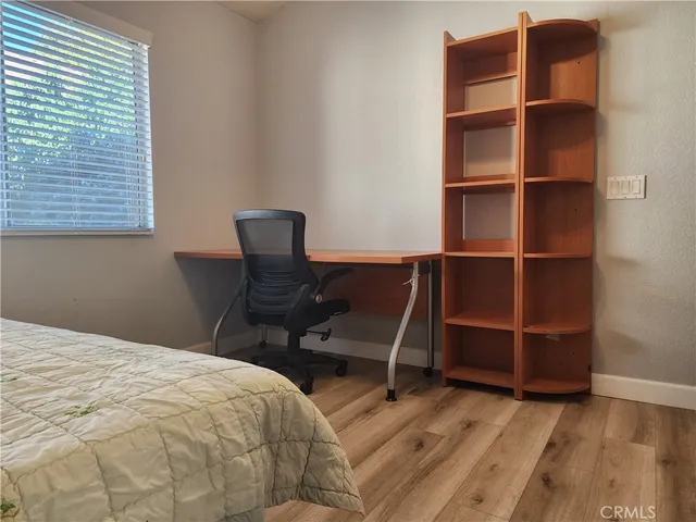 a bedroom with a bed and a chair