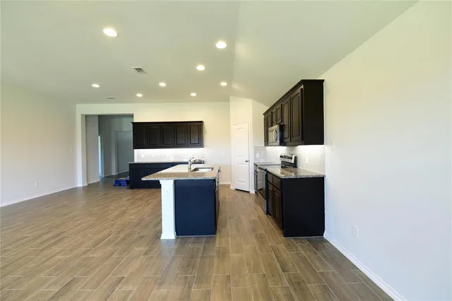 a view of kitchen with microwave oven and cabinets