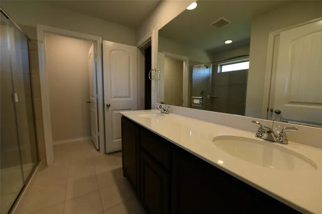 a bathroom with a double vanity sink and a mirror
