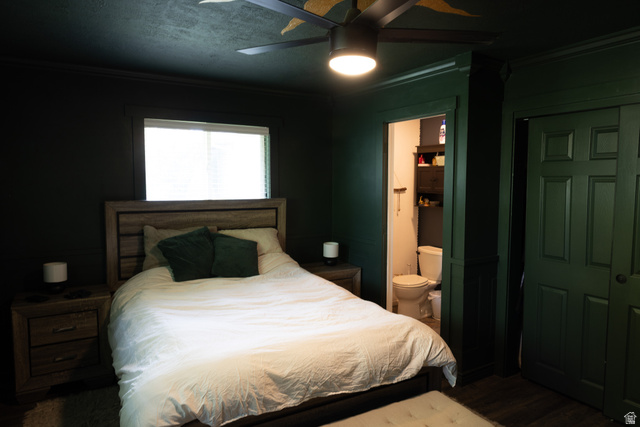 827 South 600 East Logan, UT 84321 - Photo 21 of 30 Bedroom featuring dark paneled walls, a ceiling fan with integrated lighting, a window with blinds, and wood-finish flooring