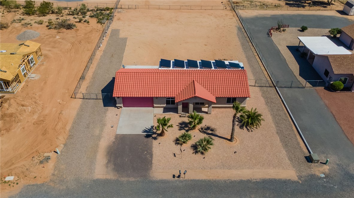 3668 North Neptune Road Golden Valley, AZ 86413 - Photo 15 of 38 The property features a red tile roof, a paved driveway, and solar panels