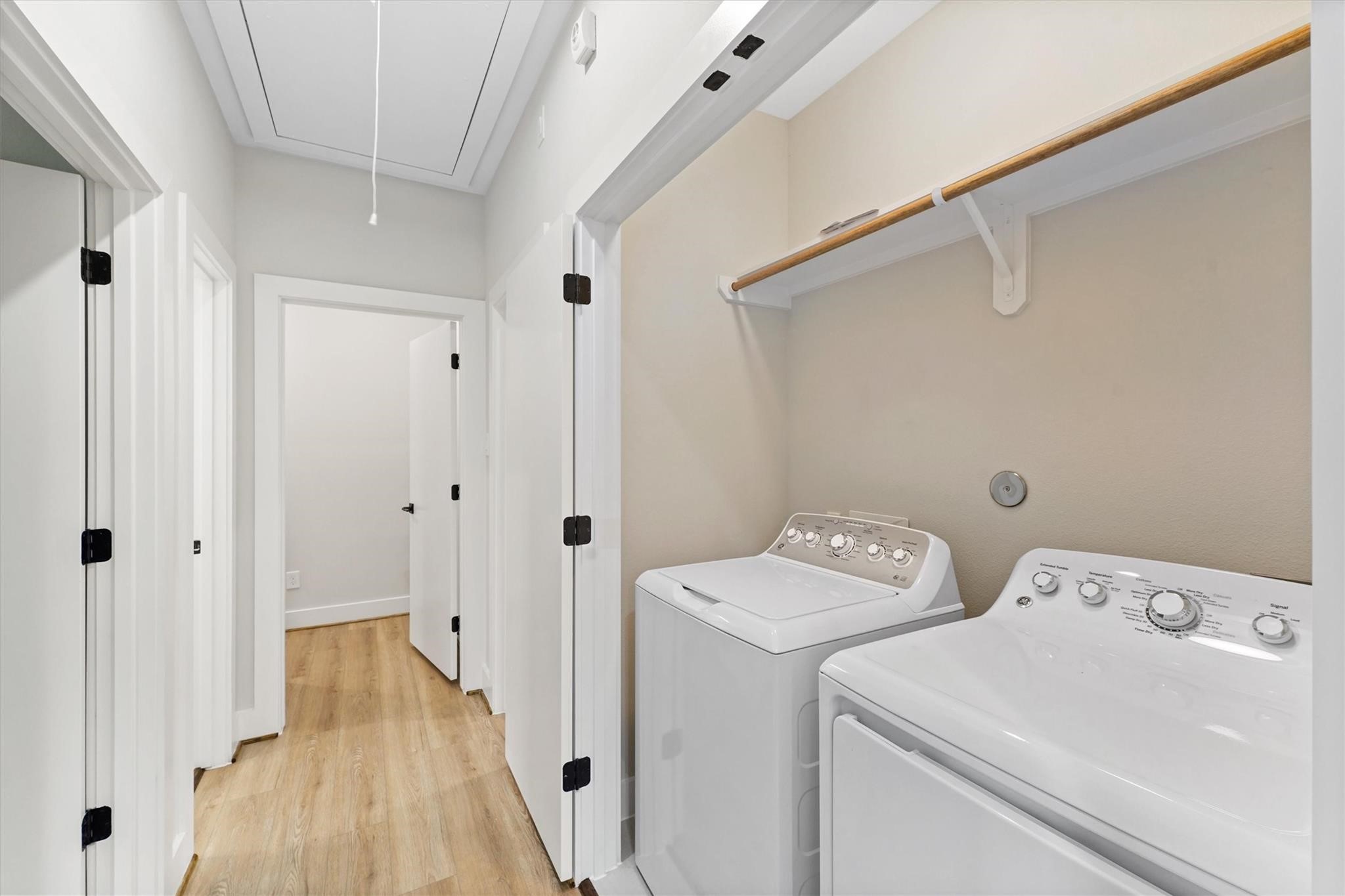 2131 Blalock Road, Unit G Houston, TX 77080 - Photo 21 of 28 a view of bathroom with a washer dryer and wooden floor