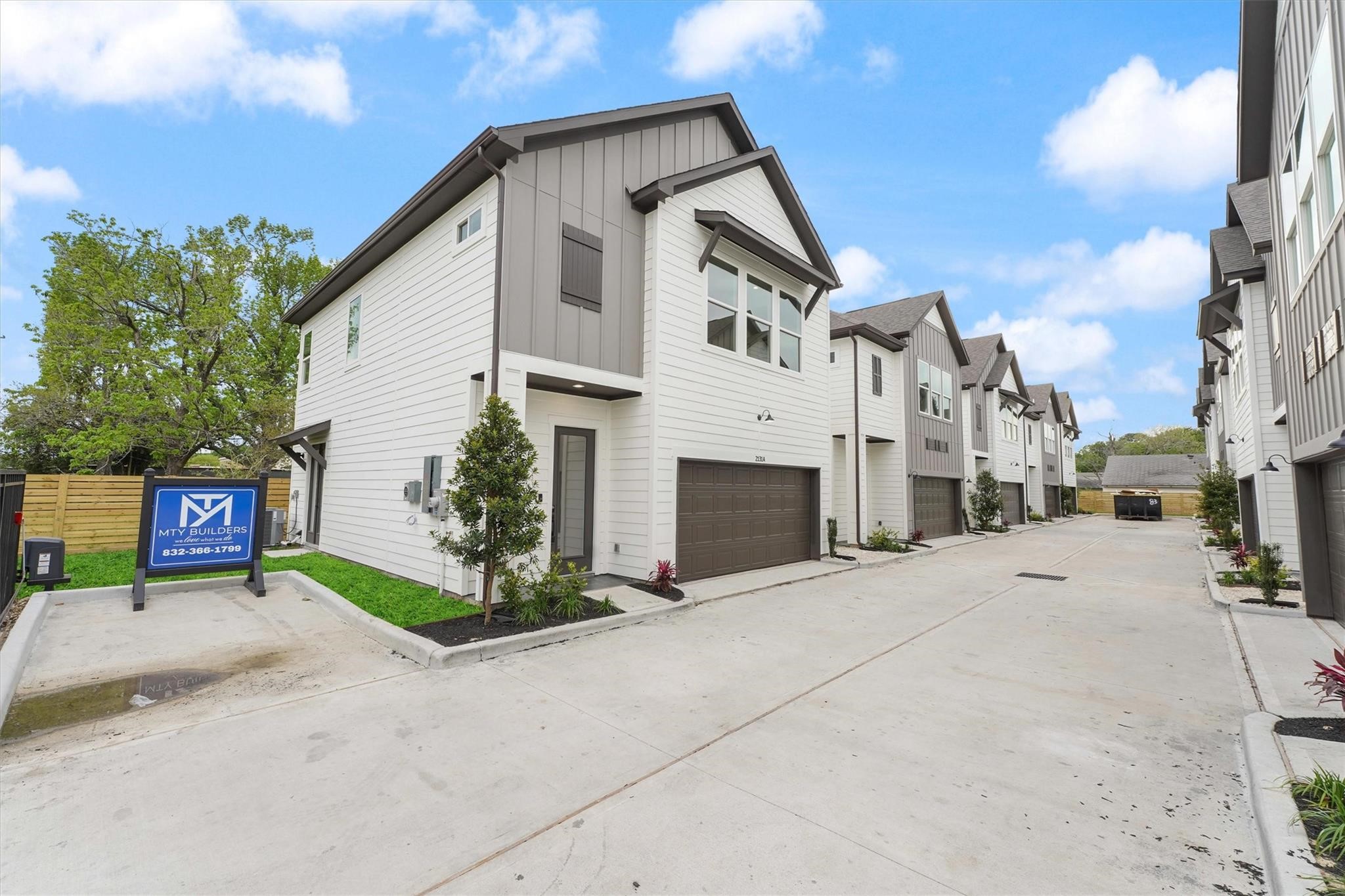 2131 Blalock Road, Unit G Houston, TX 77080 - Photo 24 of 28 a view of a white house with a large parking space and a street view