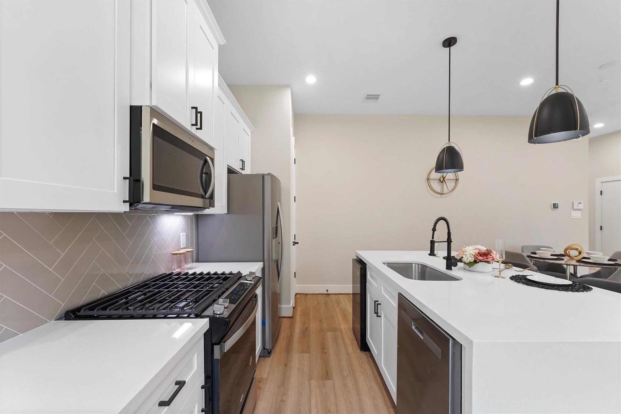 2131 Blalock Road, Unit G Houston, TX 77080 - Photo 9 of 28 a kitchen with a sink a stove and wooden floor